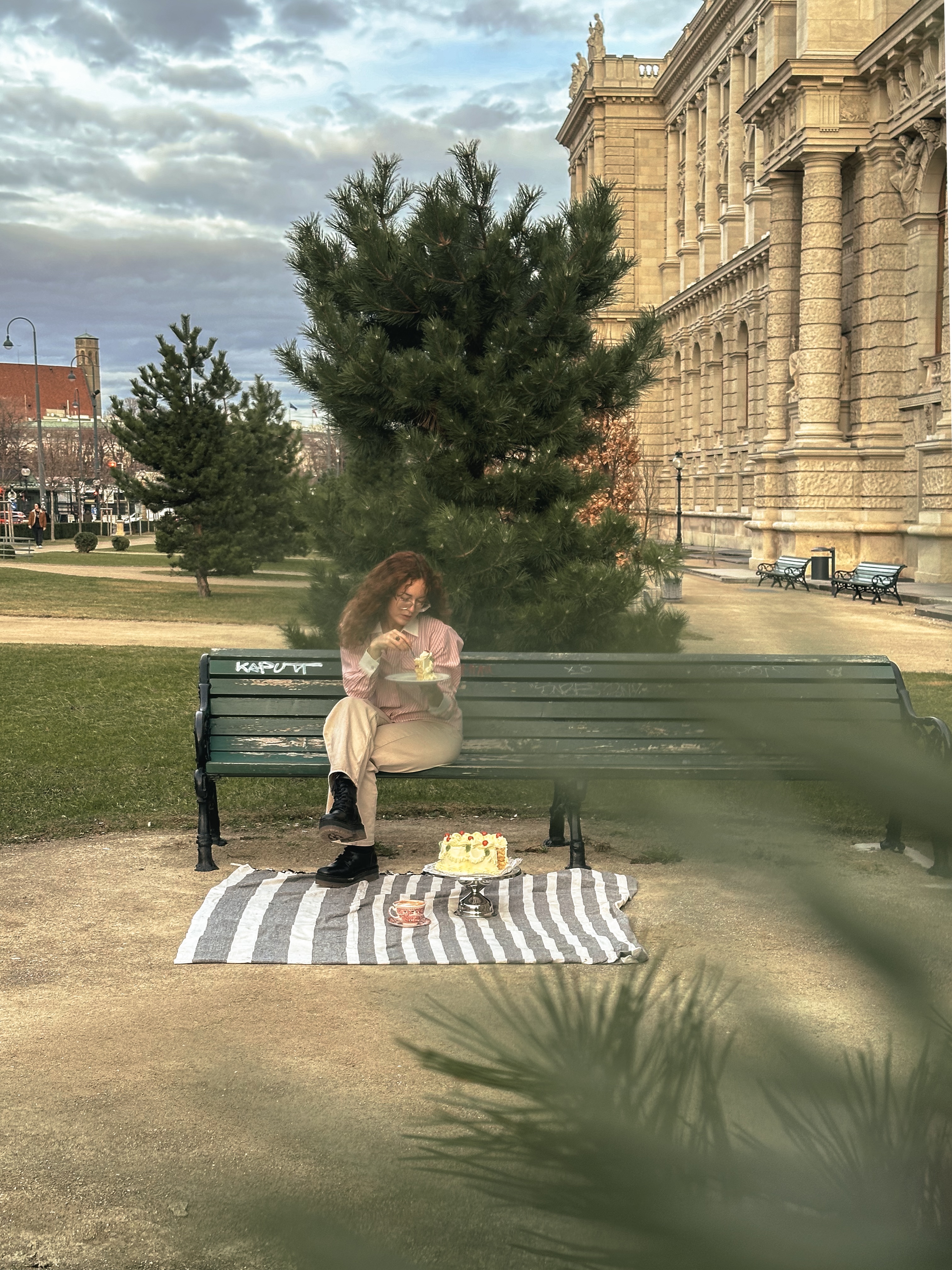 a girl eating cake in the city
