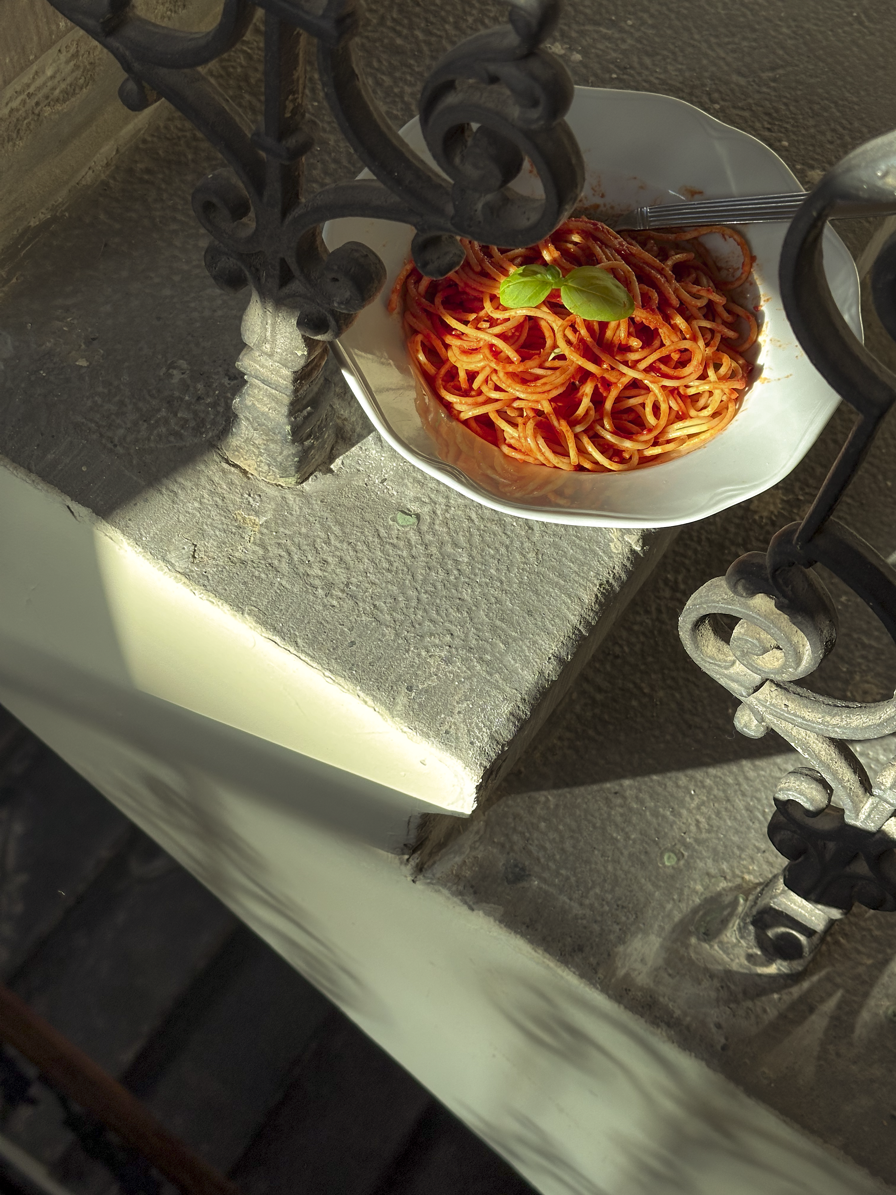 a bowl of spaghetti on a staircase